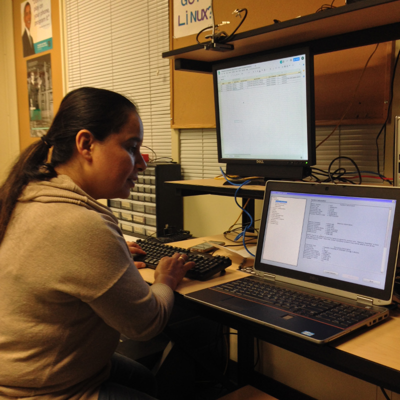 Beatriz installing Ubuntu on donated laptops for ACHS
